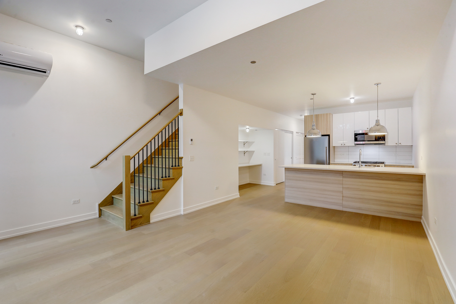 Kitchen with wood flooring and stainless steel appliances