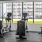 Gym with equipment facing large windows at The Heron apartments in Edgewater