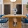 Community workspace with tables and chairs at The Heron apartments in Edgewater
