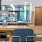 Community workspace with tables and chairs at The Heron apartments in Edgewater