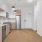 Spacious kitchen with stainless steel appliances and floating shelves