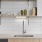 Kitchen with tiled backsplash and hanging shelves