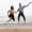 two people jumping on a beach