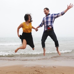 Celebrate National Relaxation Day in our safe and serene environment two people jumping on a beach