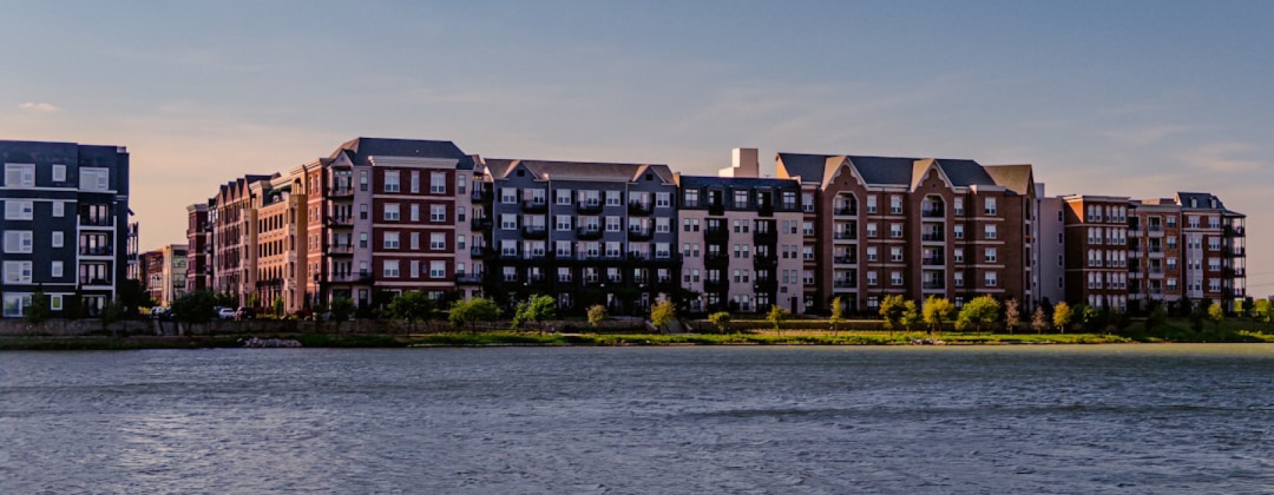 Modern edgewater apartment complex exterior near the water