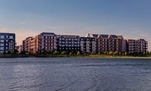 Modern edgewater apartment complex exterior near the water